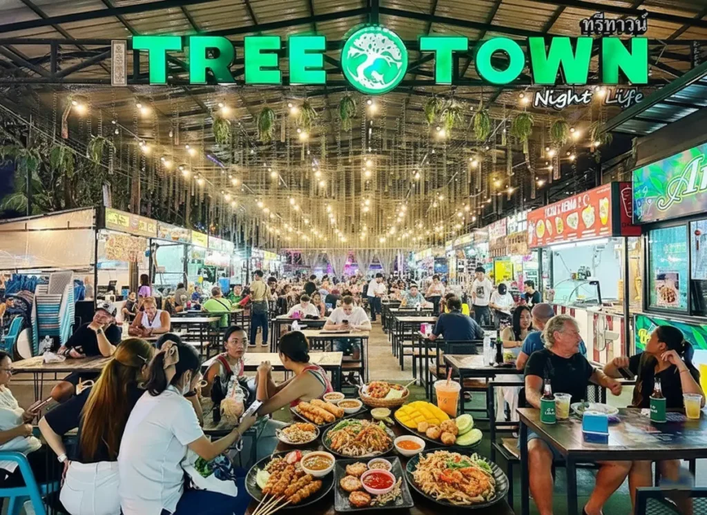 TreeTown Food Zone at night with open-air bars and food stalls, outdoor seating, neon signage, and people dining and drinking in central Pattaya.