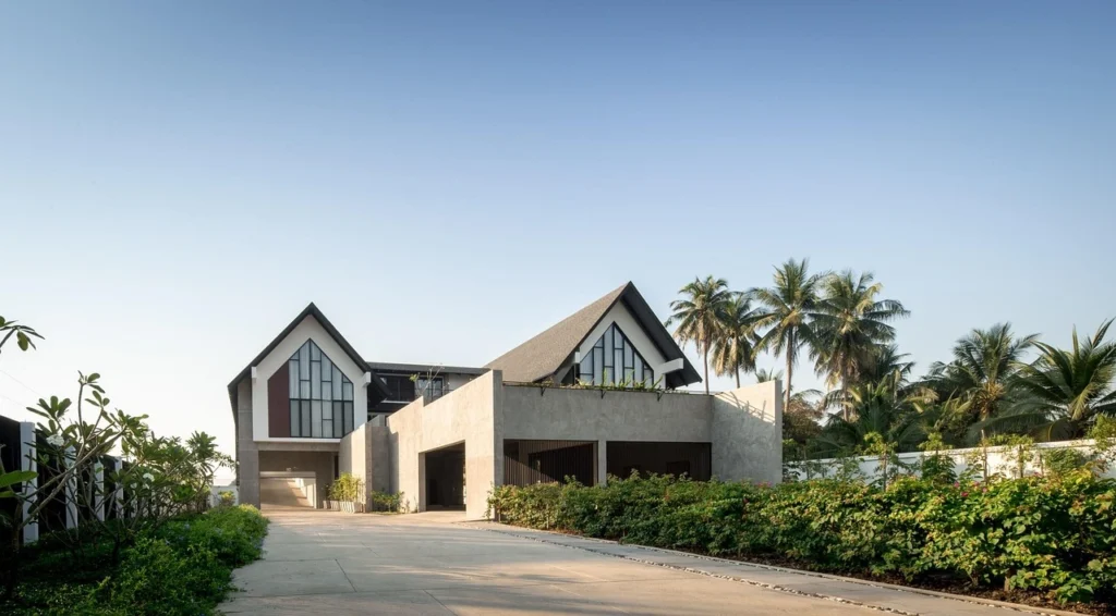 Mexican villa house with terracotta tile roof and white stucco exterior, featuring arched doorways, a landscaped courtyard, and tropical surroundings—ideal retirement or expat home in Mexico.
